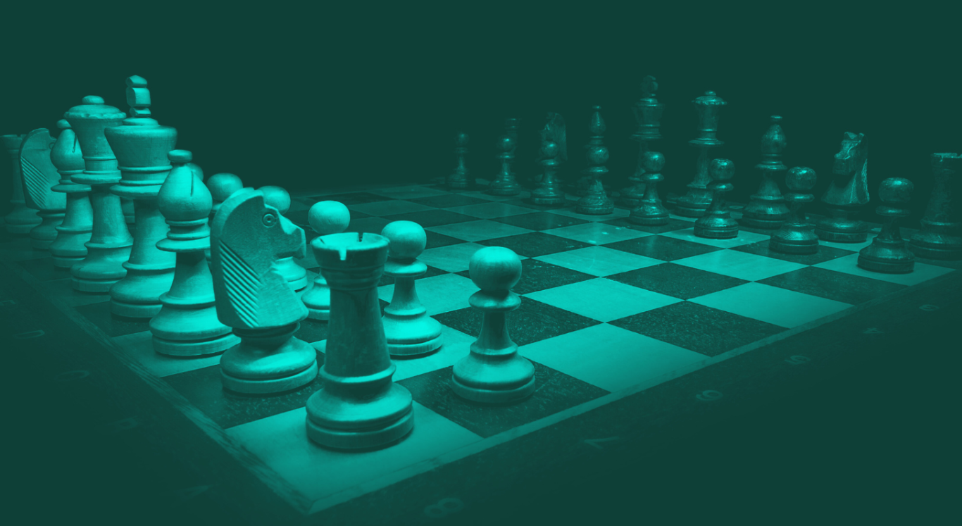 Chessboard Symbolising strategic complexity Chess pieces arranged on a dark board, illuminated in green tones. Symbolising strategic complexity