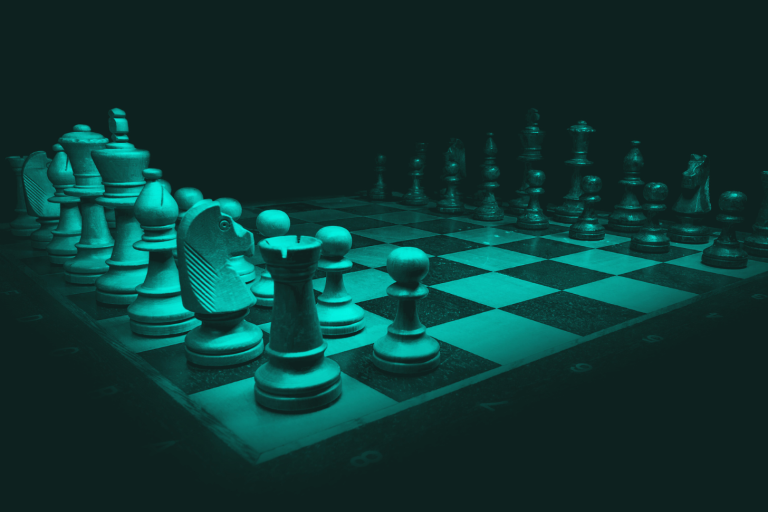 A close-up view of a chessboard with pieces arranged in a game. Symbolising strategic complexity